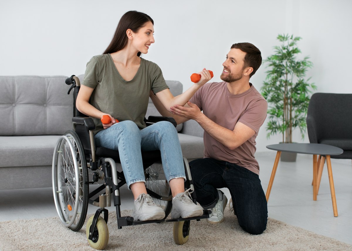 Therapist supporting a participant using a wheelchair to build strength and independence